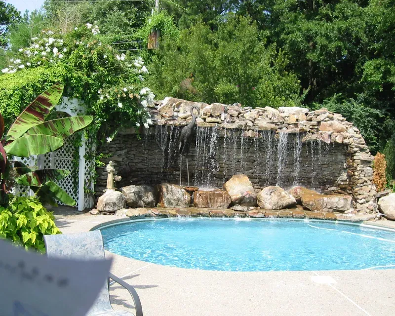 Pool construction with a large sandstone waterfall.