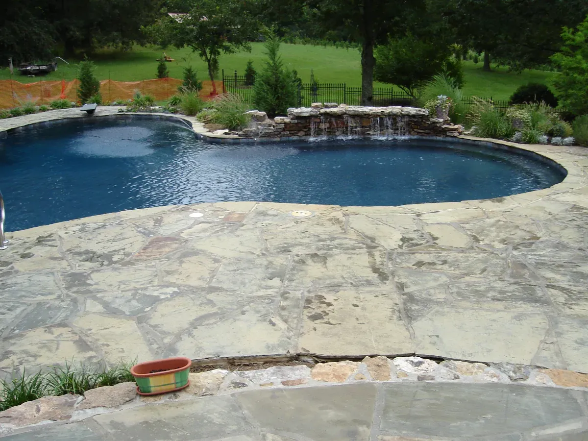 Natural stone pool deck with gunite pool.